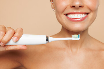 Close up cropped beautiful half naked topless young woman 20s with nude make up brush teeth...