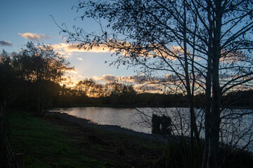 Beautiful sunset over a lake at Rushcliffe Country Park in Nottinghamshire, UK.