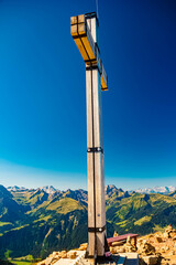 Alpine summer view with a summit cross at Mount Diedamskopf, Schoppernau, Bregenz, Vorarlberg, Austria