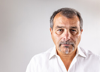 Close-up headshot highlights natural wrinkles, facial hair, and emotion, conveying authenticity, wisdom, and confidence in aging.