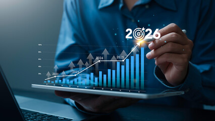 Businessman analysis the graph of trend market growth in 2026 and financial strategy, KPI dashboard report with Arrow charts, new year resolution and Strategy business. goals plan and action