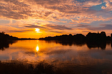 Summer sunset or sundowner view with reflections near Stephansposching, Danube, Deggendorf, Bavaria, Germany