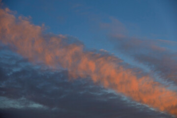 Pink and dark blue clouds streak across the evening sky. A beautiful sunset backdrop