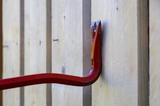 Removing a nail from a wooden board using a crowbar. Construction and repair tools
