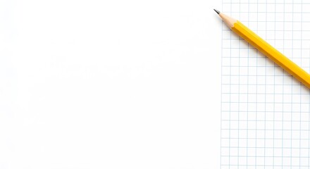Yellow pencil rests on a grid paper notebook with white pages and blue lines