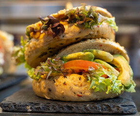 Fresh Avocado Sandwich with Lettuce and Tomato on Slate Plate