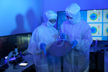 Technician working on analyzing semiconductor or microchip boards, electronics industry, electronic...