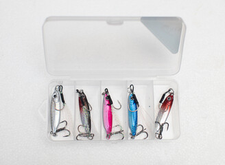 10g multi-colored micro metal jig lures in a plastic box placed on a wood pattern surface.