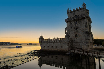 Historic 16th century Belem Tower on the bank of Tagus River at sunset in Lisbon