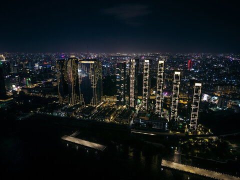 Nighttime cityscape with illuminated skyscrapers and densely populated urban skyline. Ho Chi Minh City, Vietnam