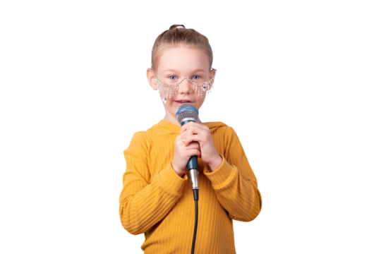 Young girl in yellow sweater singing into microphone, wearing decorative glasses, isolated on transparent background. Perfect for music, education, and lifestyle concepts.
