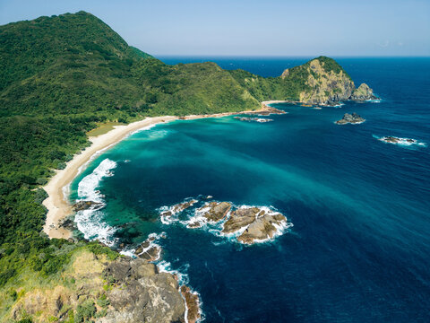 Aerial view of a scenic tropical coastline with lush greenery and turquoise ocean waters. Pantai Telawas Beach, Mekar Sari, Praya Barat, Central Lombok Regency, West Nusa Tenggara, Indonesia