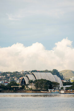 Scenic view of a coastal town with a unique architectural building and cloudy sky. Ambon, Maluku, Indonesia