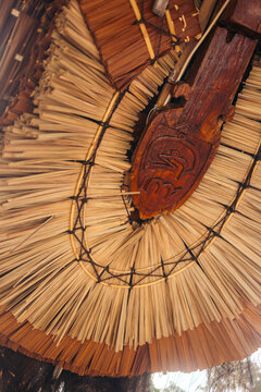 Close-up of traditional thatched roof with intricate wooden details and woven patterns. Ambon, Maluku, Indonesia