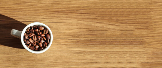 coffee cup filled beans wooden background copy space banner. minimalist coffee cup filled beans...