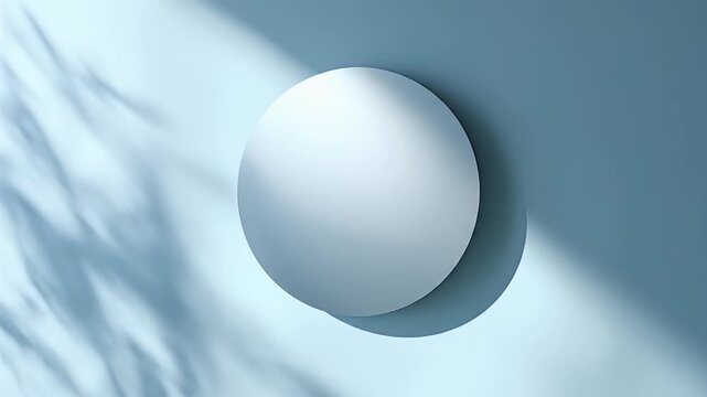 A large, round, white object casts a shadow on a cool blue background, with leaf shadows