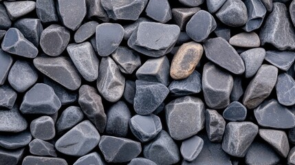 Abstract view of railroad tracks with gray pebbles highlighting the texture and pattern in a natural setting during daylight