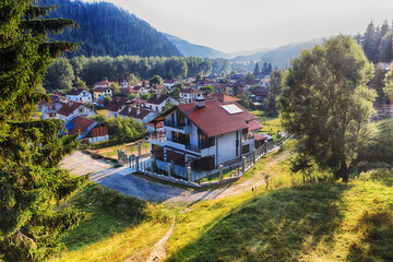 Drone view of Madzhare village with modern house and forest hills