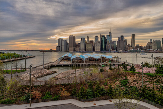 Brooklyn Bridge Park offers a stunning view of the Manhattan skyline at sunset. New York City, NY, USA