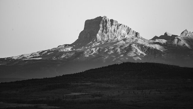 Black and white mountain landscape with rugged terrain and dramatic shadows. Waterton Lakes National Park, Alberta, Canada