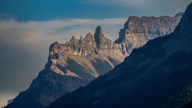 Majestic mountain range under a clear blue sky at sunset. Waterton Park, Alberta, Canada