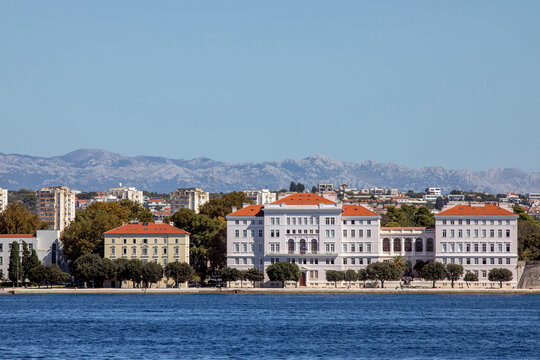 Coastal city skyline with historic buildings and mountains in the background. Zadar, Croatia