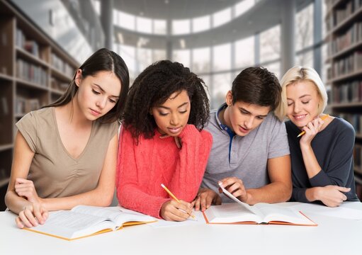Group of high school smart students friends in bright library