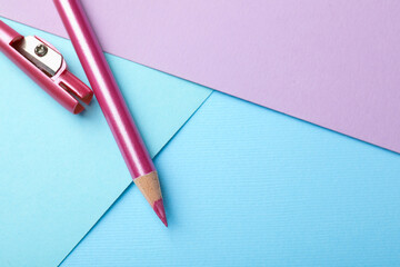 Eye pencil with sharpener on color background, flat lay. Space for text