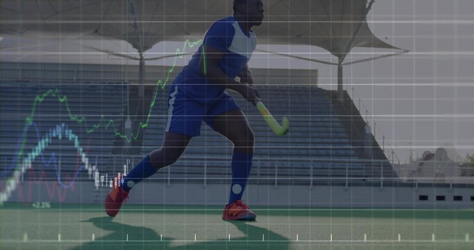 Striding field hockey player wearing blue uniform holding neon stick on turf, with grid overlay