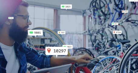 Leaning bicycle technician checking red bicycle gears at bike shop, with tablet overlay, copy space