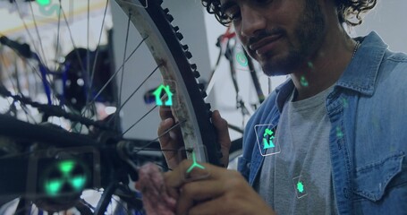 Denim shirt mechanic wiping bicycle wheel in repair workshop, with rag and AR icons, copy space