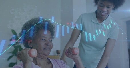 Lifting senior woman gripping pink dumbbells at shoulder-height in living room, caregiver support
