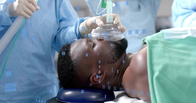 Holding anesthesia mask, staff in scrubs securing patient airway in operating room, with drape - Powered by Adobe