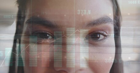 Analyzing mid adult woman engaging with financial data overlays at office desk, digital interface