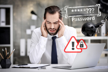 Troubled young man trying to remember his password at workplace in office