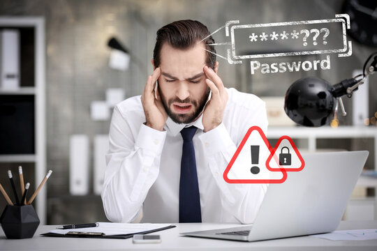 Troubled young man trying to remember his password at workplace in office