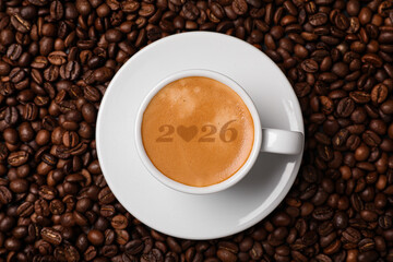 Hello New 2026 Year. Cup of coffee with numbers on roasted beans, top view