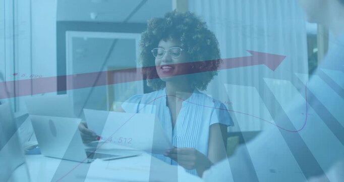 Female professional opening folder and laying out charts at desk, red arrow showing business growth