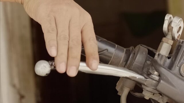 Close-up hand pulling motorcycle front brake lever