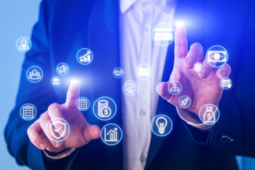 Businessman interacting with digital icons representing finance, technology, and data analysis in a modern setting
