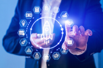 Business professional using digital technology to interact with innovation icons in a modern office setting