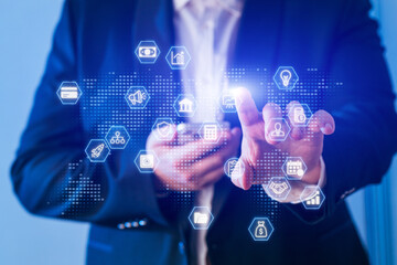 Businessman interacting with digital icons and data on a mobile device during an office meeting