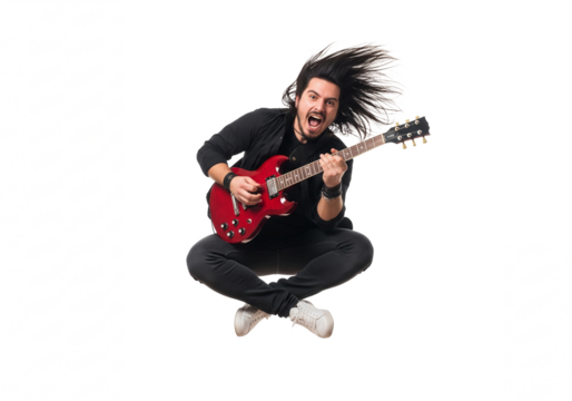 Energetic young man with long dark hair playing a red electric guitar while jumping isolated on transparent background