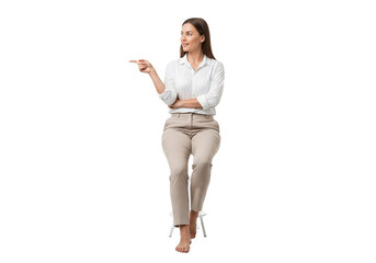 Young woman sitting on a stool pointing to the side with a smile isolated on transparent background