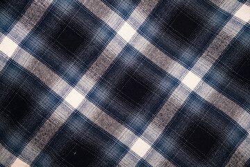 A rugged and soft flannel plaid fabric in dark tones, featuring a large, classic check pattern in navy blue, black, gray, and off-white. Perfect for grunge, lumberjack, or cozy winter fashion themes