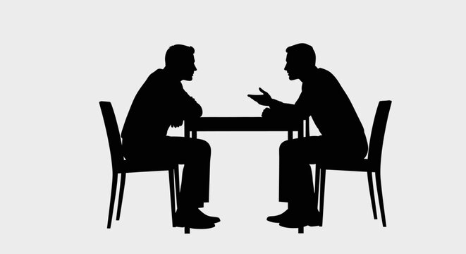 Silhouettes of two men sitting at a table, facing each other, engaged in a discussion or meeting