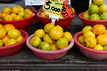Korean tangerines or Gyul sold in Jeju Island. Translation: One basket for five thousand Korean won.
