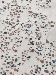 Colorful Pebbles and Stones on Light Sand – Natural Beach Texture Background
