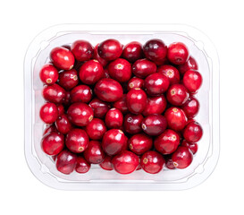 Fresh cranberries, bearberries, or American cranberries, in a clear plastic container, from above. Ripe, bright red, large cranberries, Vaccinium macrocarpon, with shiny skin and acidic taste.