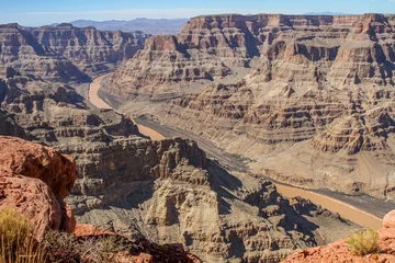 Fototapete Naturpark A panoramic view of the Grand Canyon with the Colorado River flowing through rocky cliffs in Arizona, USA. A stunning natural landscape, geological formation, and popular tourist destination.  © Pavel